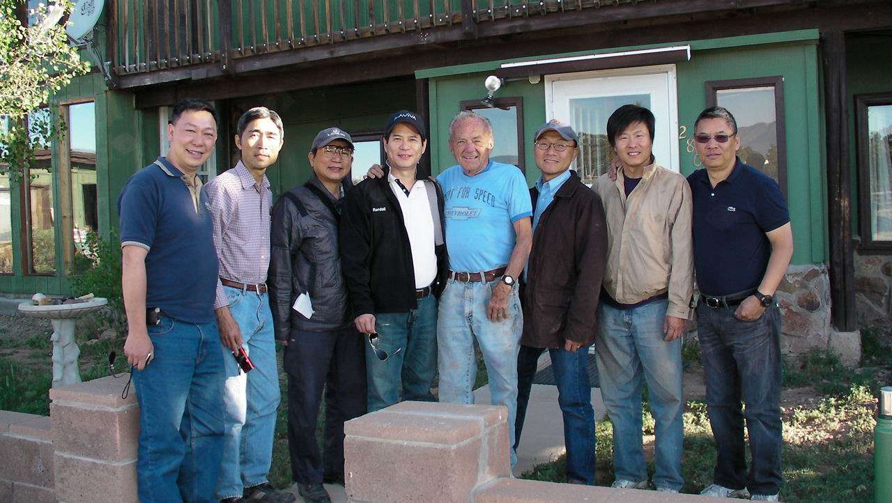 Entire crew with Mr. Loeffler taking picture in front of Mr. Loeffler's house